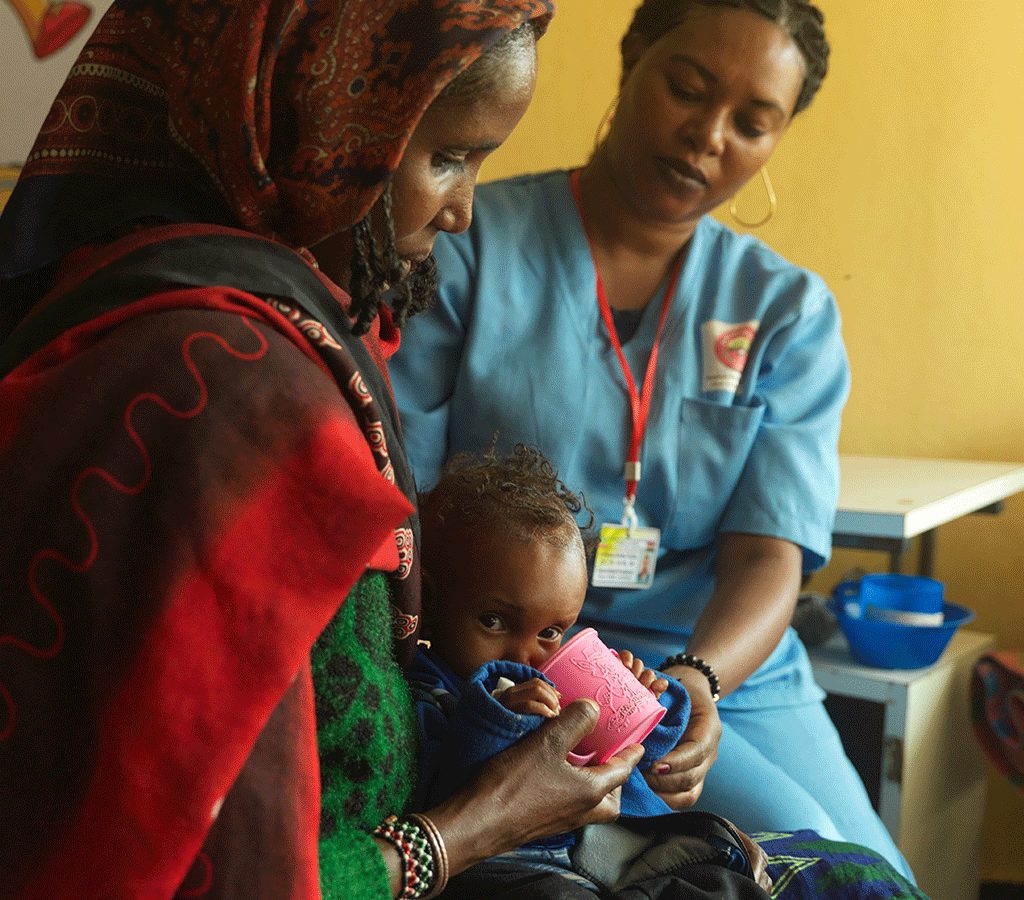 Ware treats Baby Dabo for malnutrition at an Action Against Hunger-supported hospital in Ethiopia