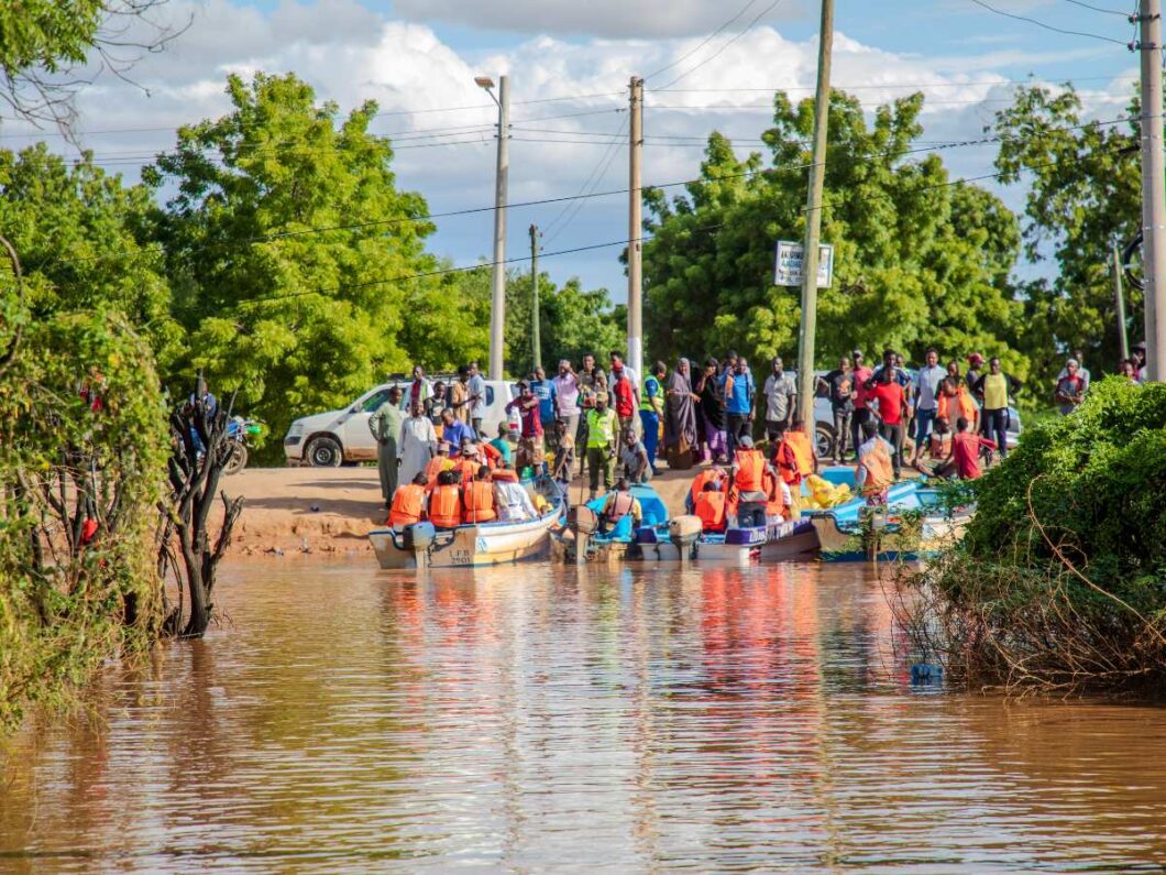 Community in Kenya gathering around flood waters caused by climate change.