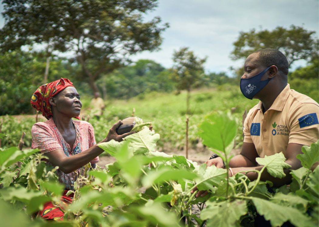 Woman farmer in DRC talks to Action Against Hunger staff.