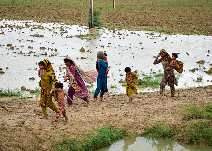 Children walk through the floods in Pakistan.