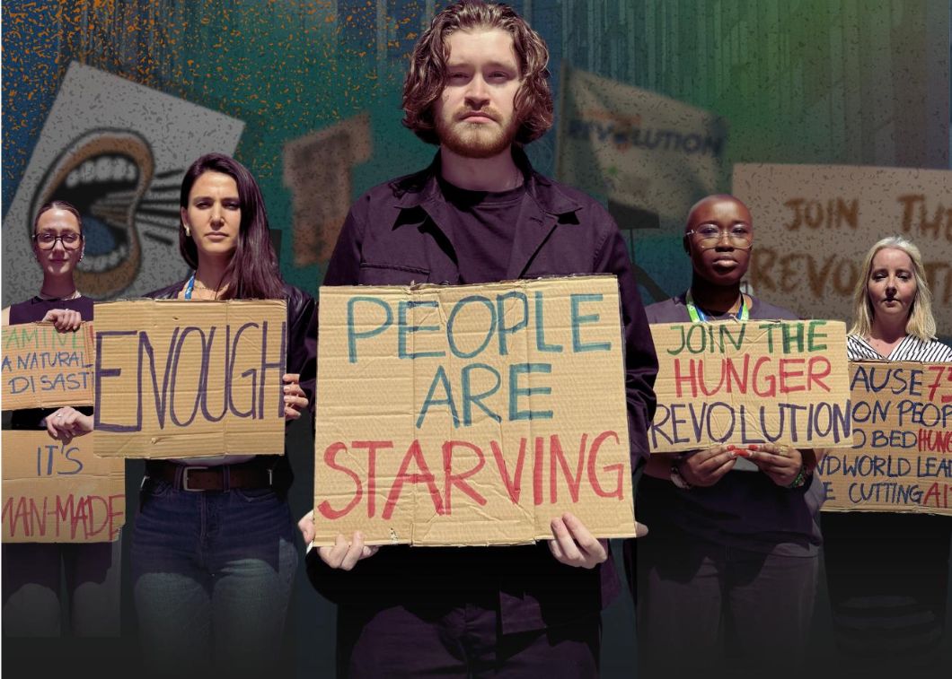 Five Action Against Hunger staff members holding up protest boards.