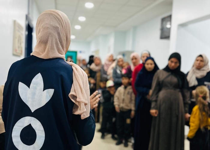 Gaza aid worker stood with pregnant mothers.