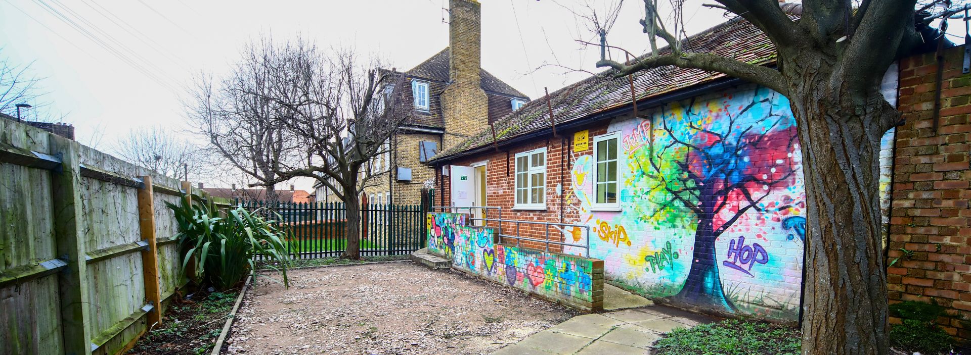 Front INI Food and Wellbeing Centre with colourful murals at entrance.