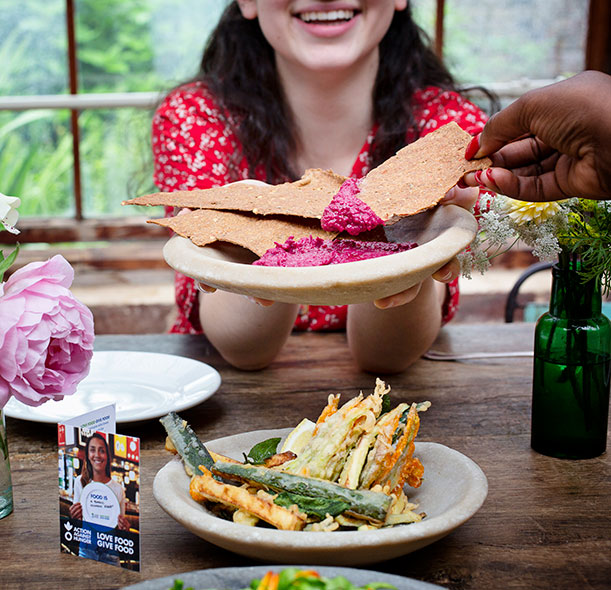 Diners enjoy food at a restaurant taking part in Action Against Hunger's Love Food Give Food campaign.