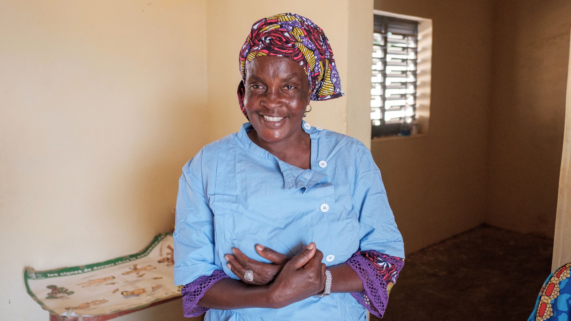 Maye, a nurse in Senegal, smiles at camera.