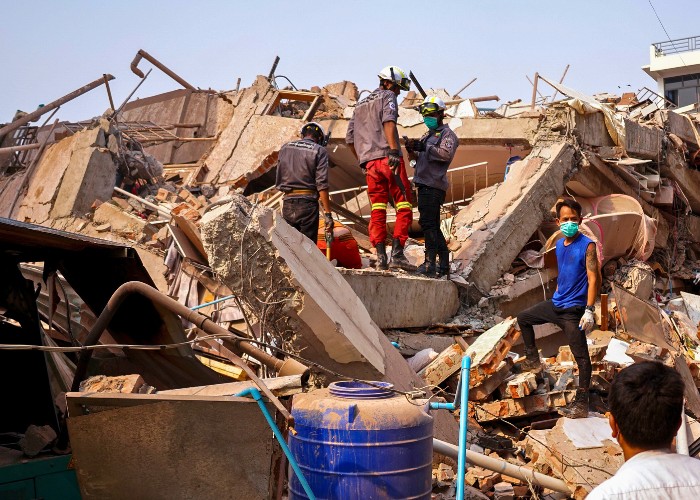 People in Myanmar clearing up after a powerful earthquake.