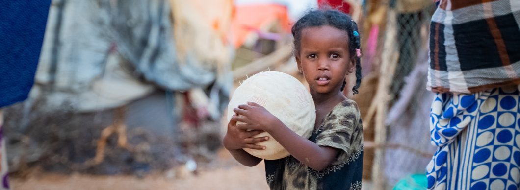 A girl holds a ball at a refugee camp in Puntland, Somalia.