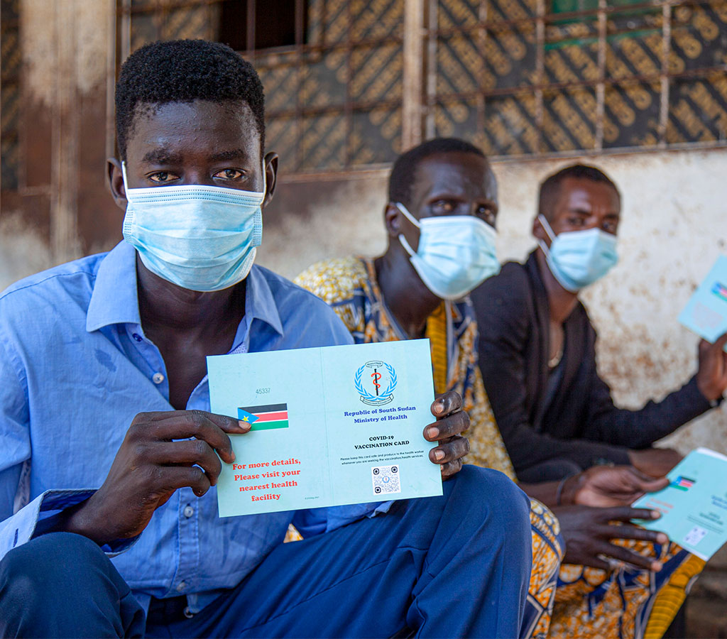 People in South Sudan show their proof of vaccination cards