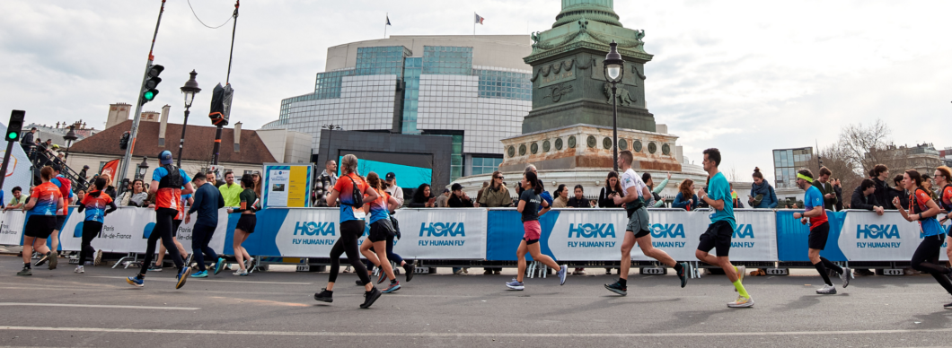 Runners running through the streets of Paris.